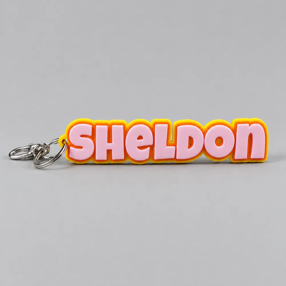 a pink and yellow name keyring